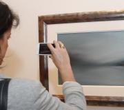 Unha muller fotografía unha das obras.