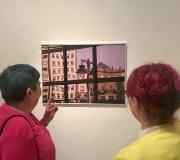 4. Dúas das asistentes á inauguración observan atentamente unha das imaxes da mostra.