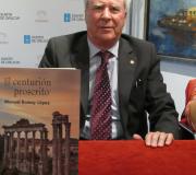 O escritor, Manuel Romay, coa novela en primeiro plano.